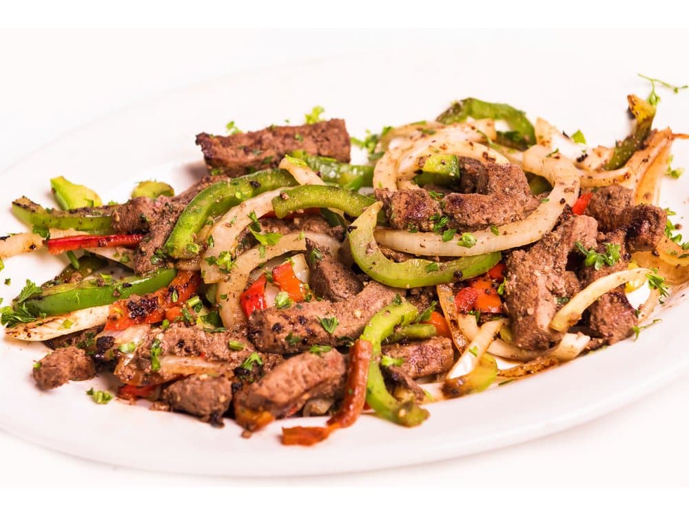 Hígado a la Italiana — USDA choice liver, cut into julienne strips, marinated, sautéed with onions, green and red peppers