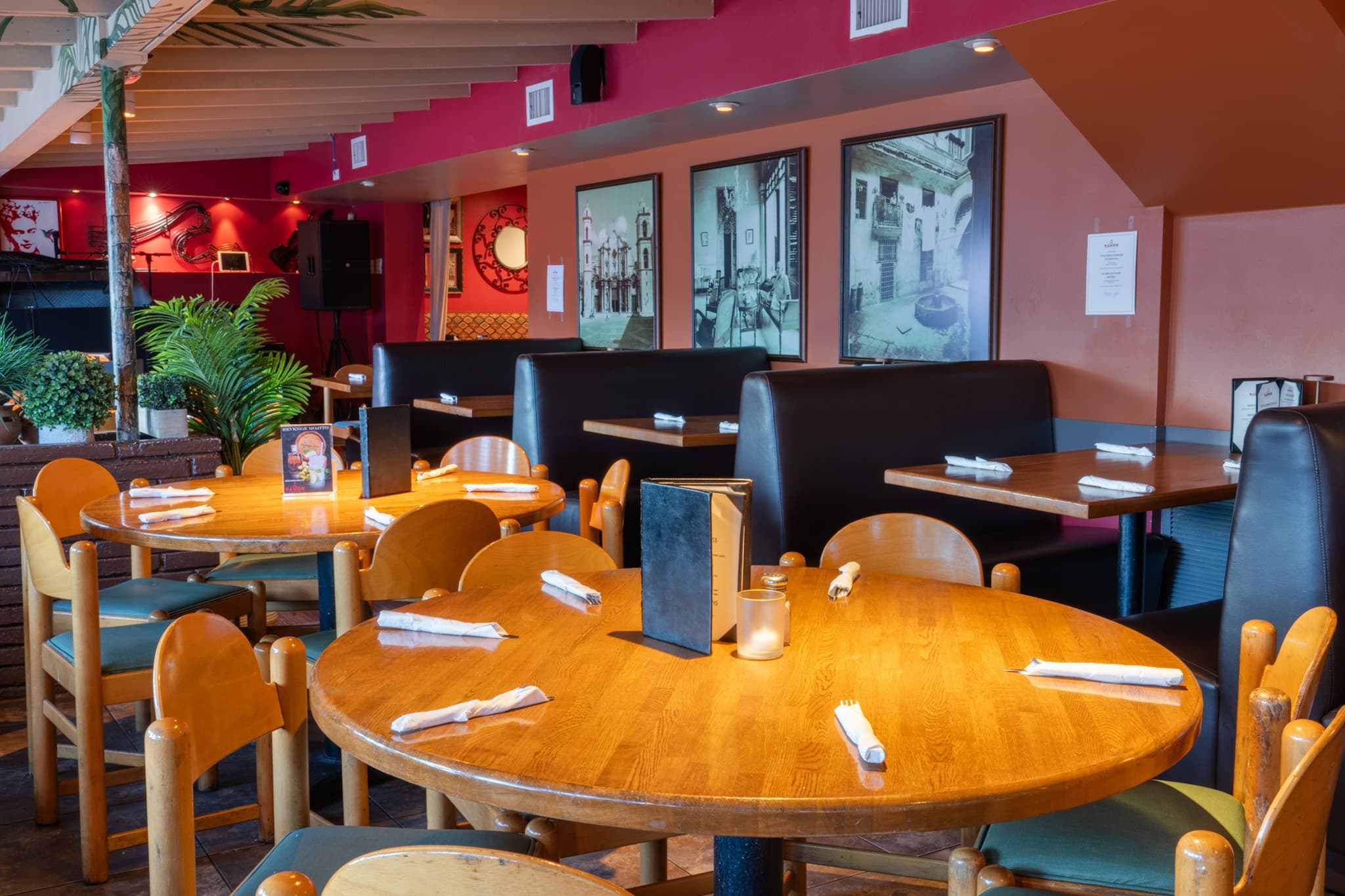 Dining tables below the black and white Havana prints