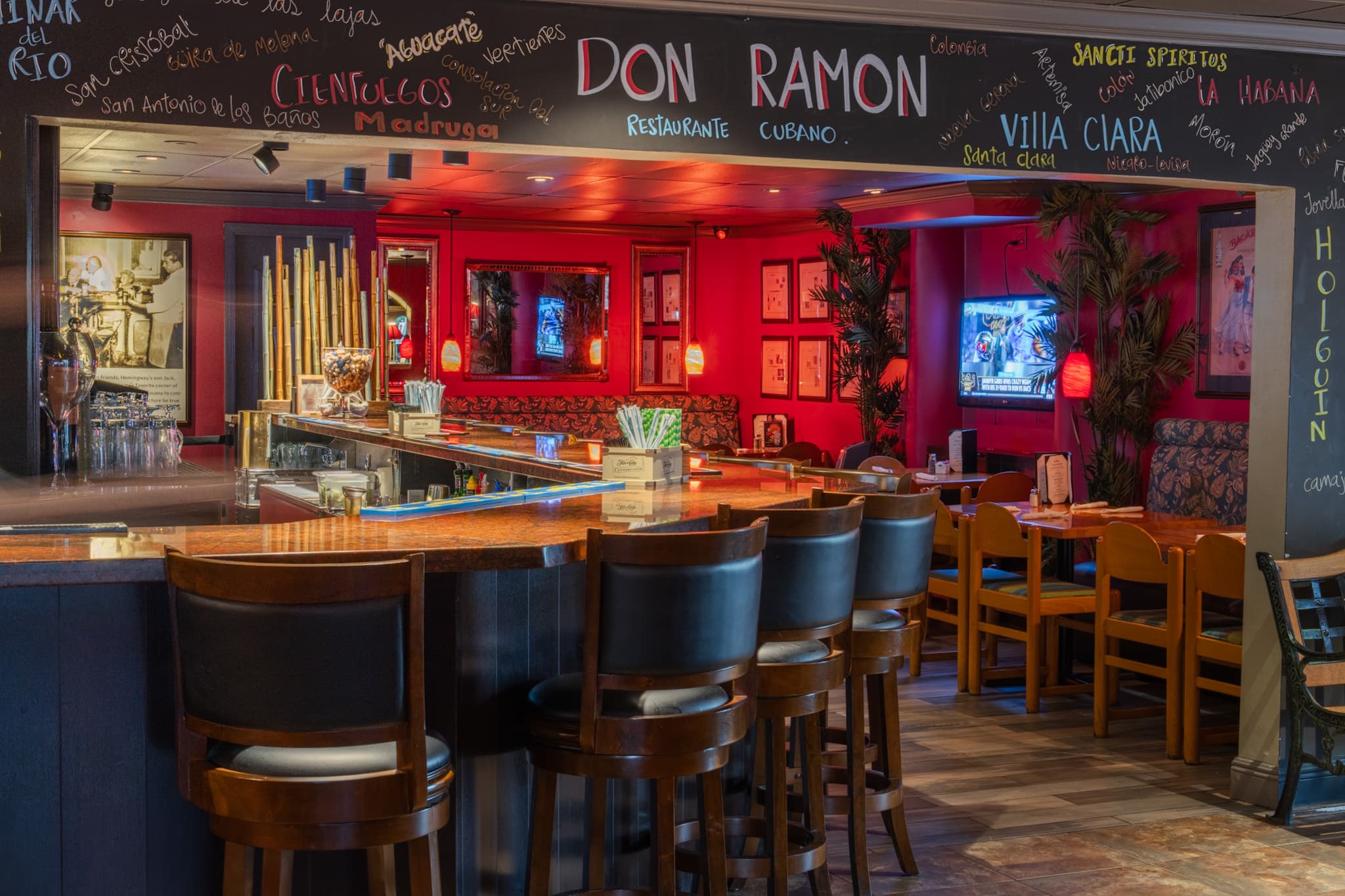 The bar at Don Ramon beneath the chalkboard mural of Cuban town names