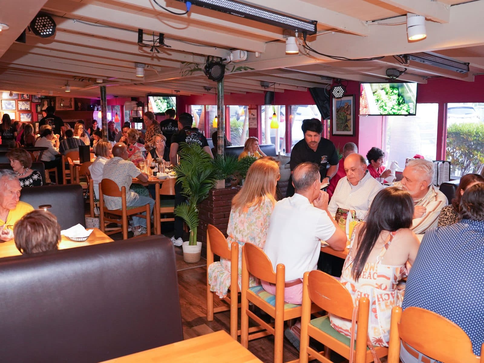A full dining room mid-service, every table taken