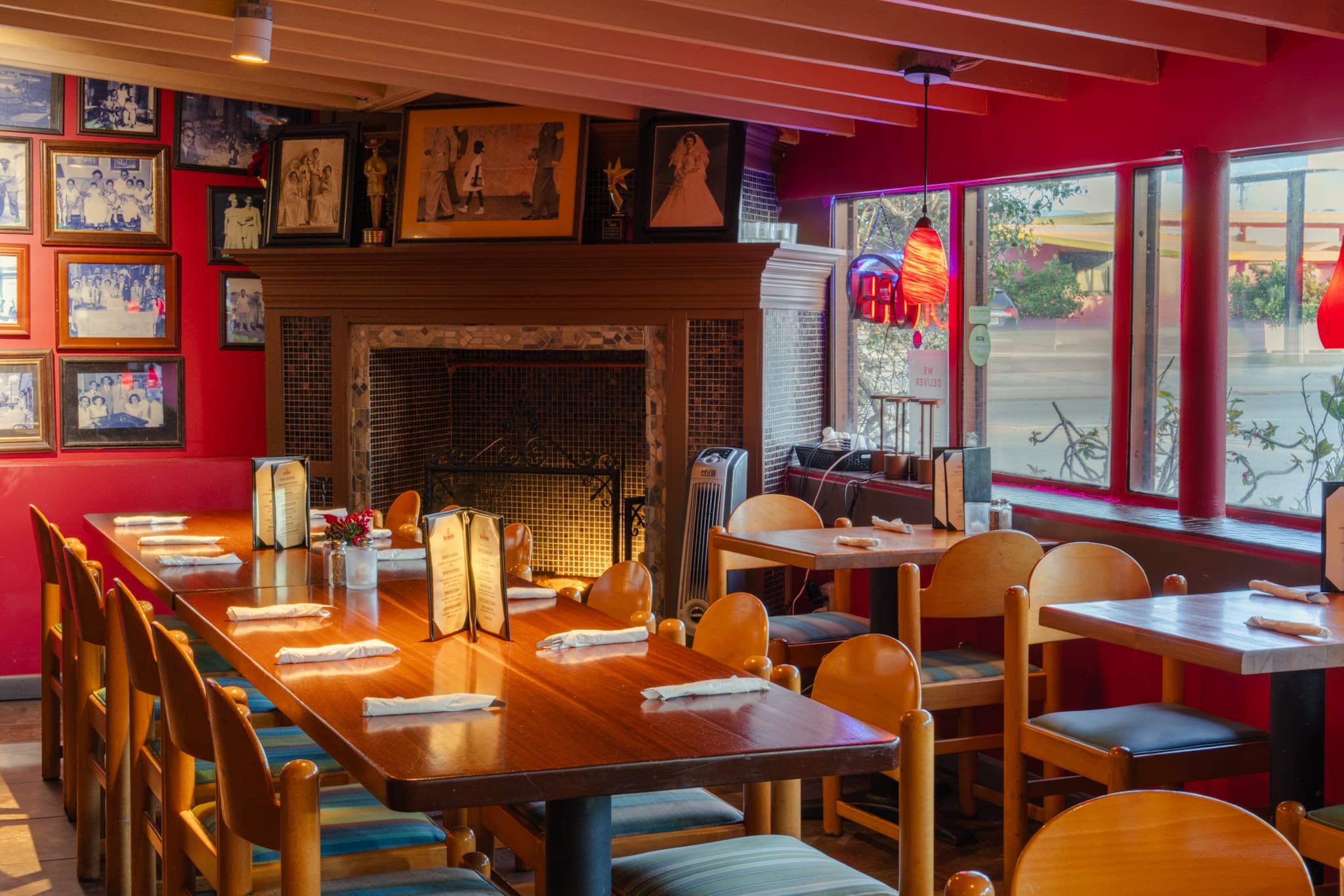 Dining tables beside the fireplace and the family photo wall