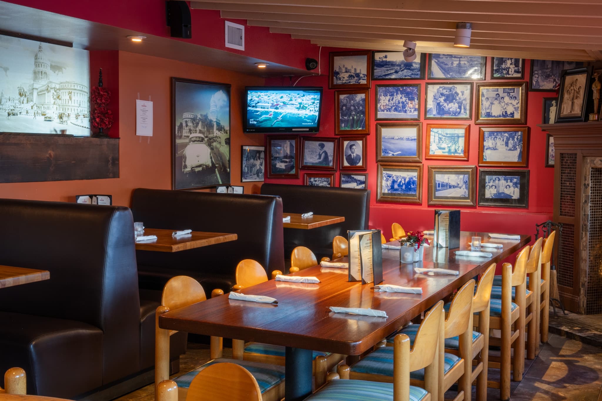 Booths beneath decades of framed photographs