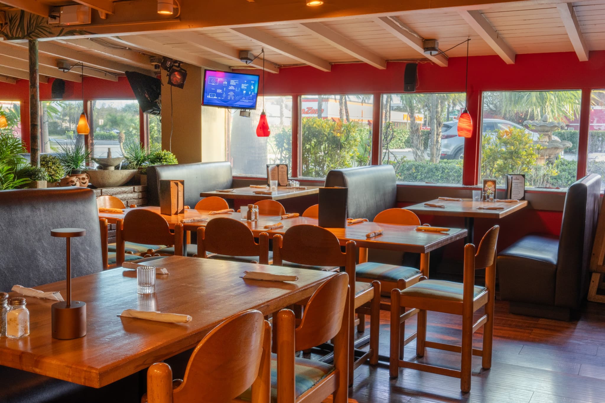 The dining room with sunlight through the front windows